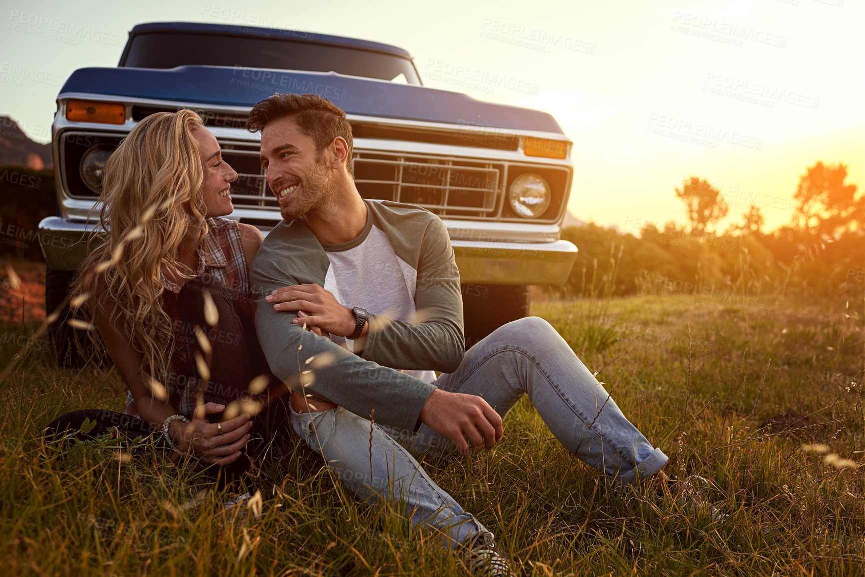 Buy stock photo Shot of an affectionate young couple on a roadtrip