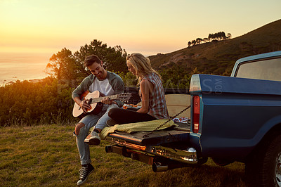 Buy stock photo Sunset, truck or couple with guitar in nature on romantic holiday vacation for bonding or relaxing on date. Car road trip, travel or people playing music in summer with romance in park field together