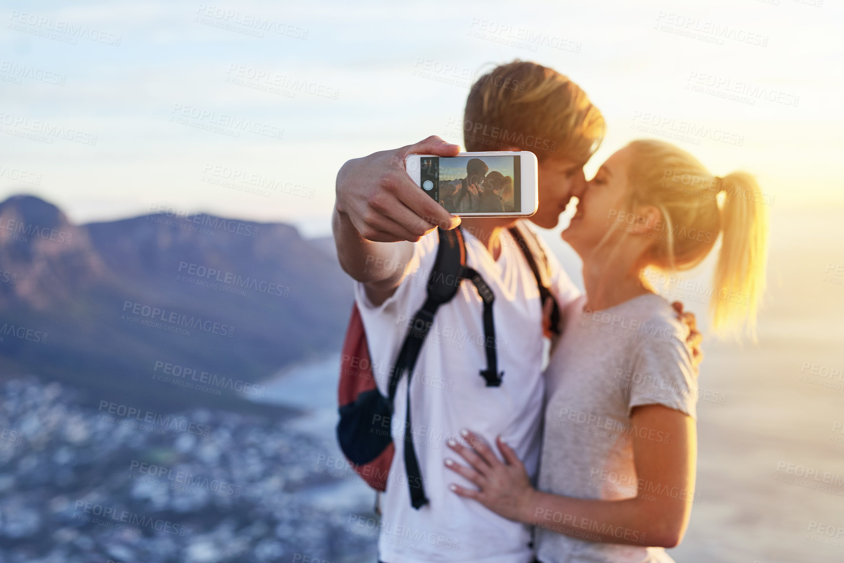 Buy stock photo Cropped shot of a young couple taking a selfie while on a hike