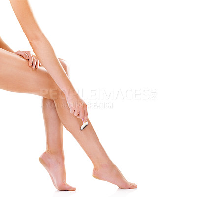 Buy stock photo Woman, legs and razor in studio, shaving and skincare for smooth skin on white background. Female person, mockup space and cosmetics treatment or dermatology, self care and blade for hair removal