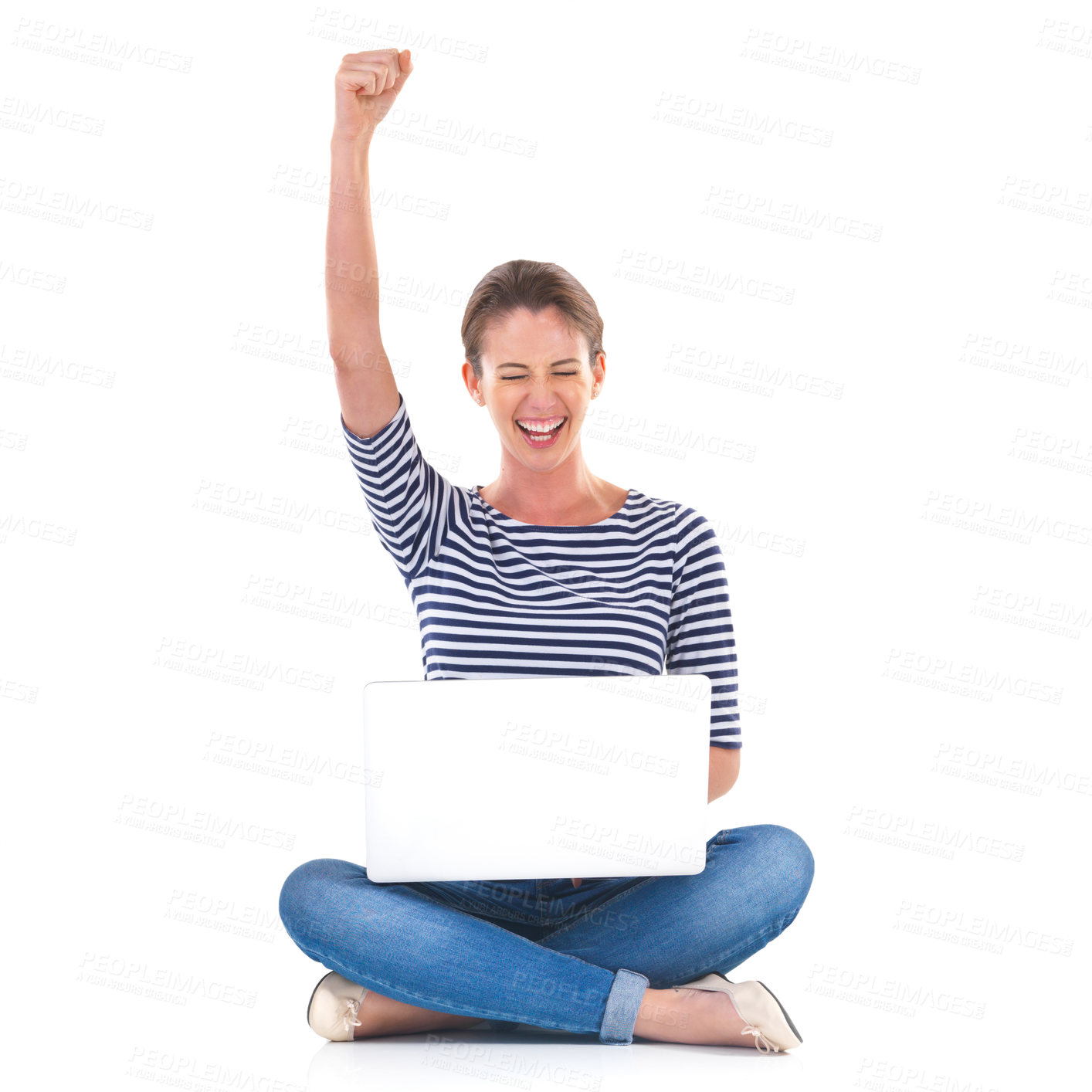 Buy stock photo Studio shot of a young woman sitting cross legged on the floor cheering while using a laptop