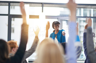 Buy stock photo Cropped shot of a group of people raising their hands in a class