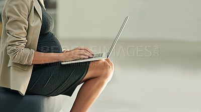 Buy stock photo Cropped shot of a pregnant businesswoman using a laptop in an office