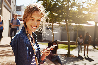 Buy stock photo Shot of a student using her cellphone on campus