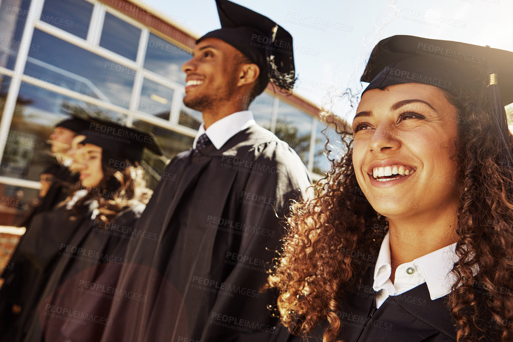 Buy stock photo Shot of a group of smiling university students outside on graduation day