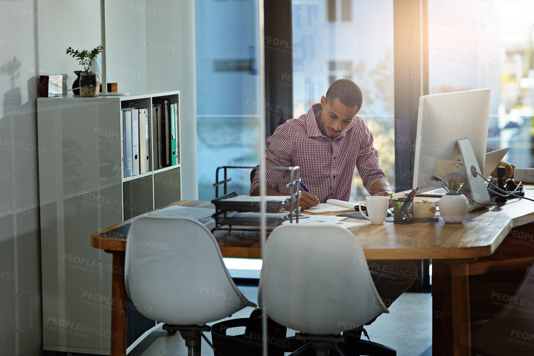 Buy stock photo Shot of a businessman working on a computer in an office