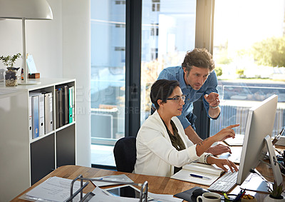 Buy stock photo Shot of businesspeople working on a computer in an office