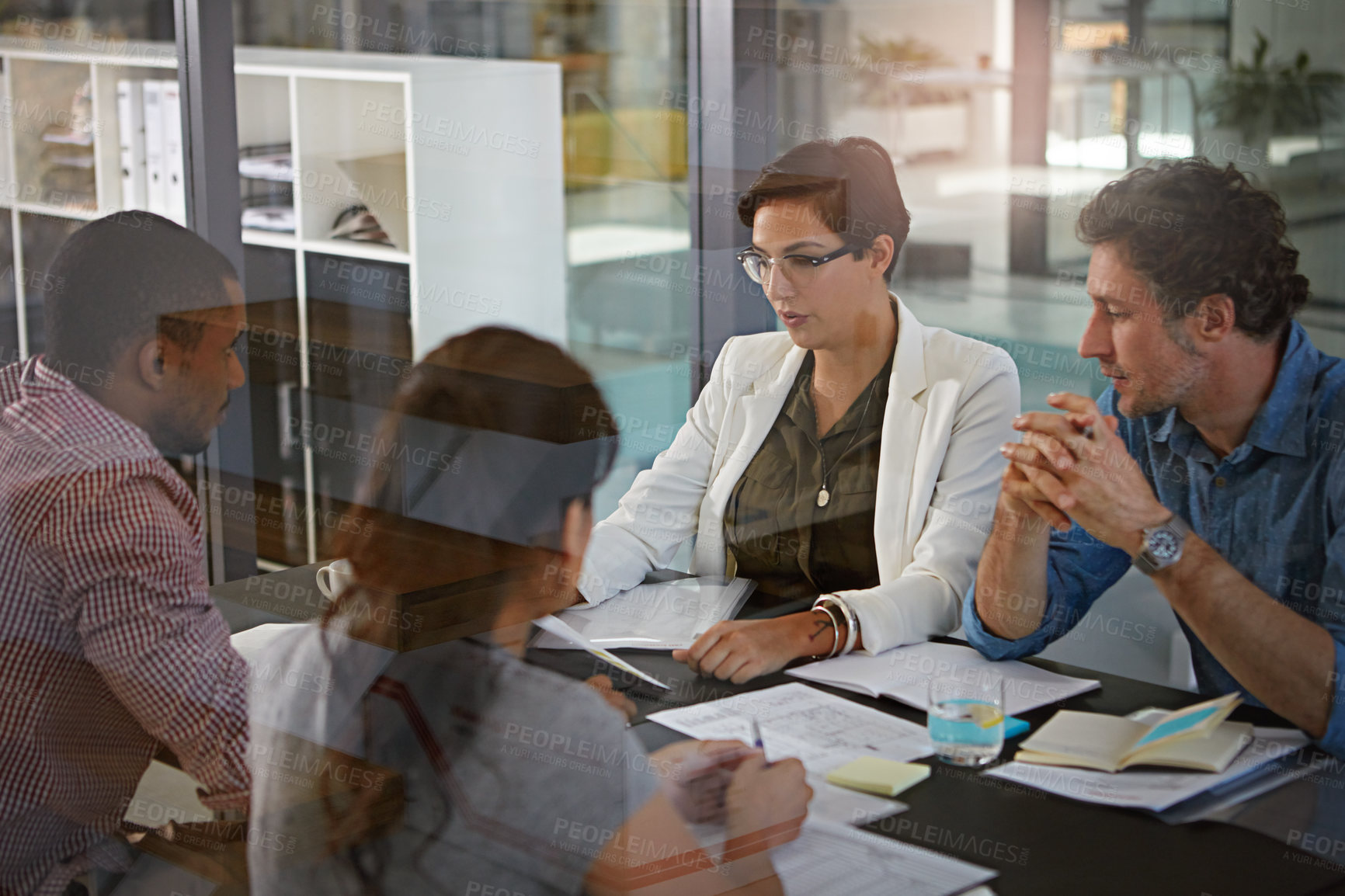 Buy stock photo Cropped shot of a group of colleagues meeting in the office