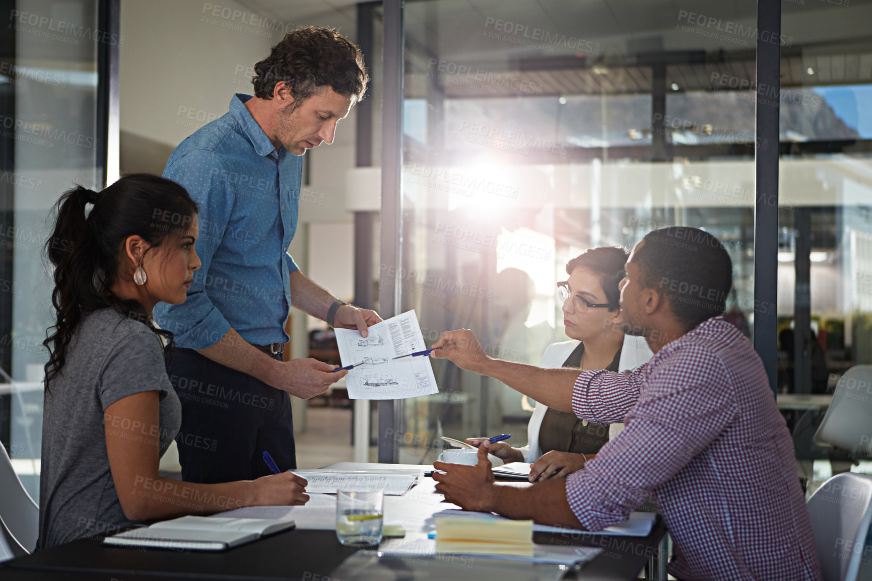 Buy stock photo Cropped shot of a group of colleagues meeting in the office