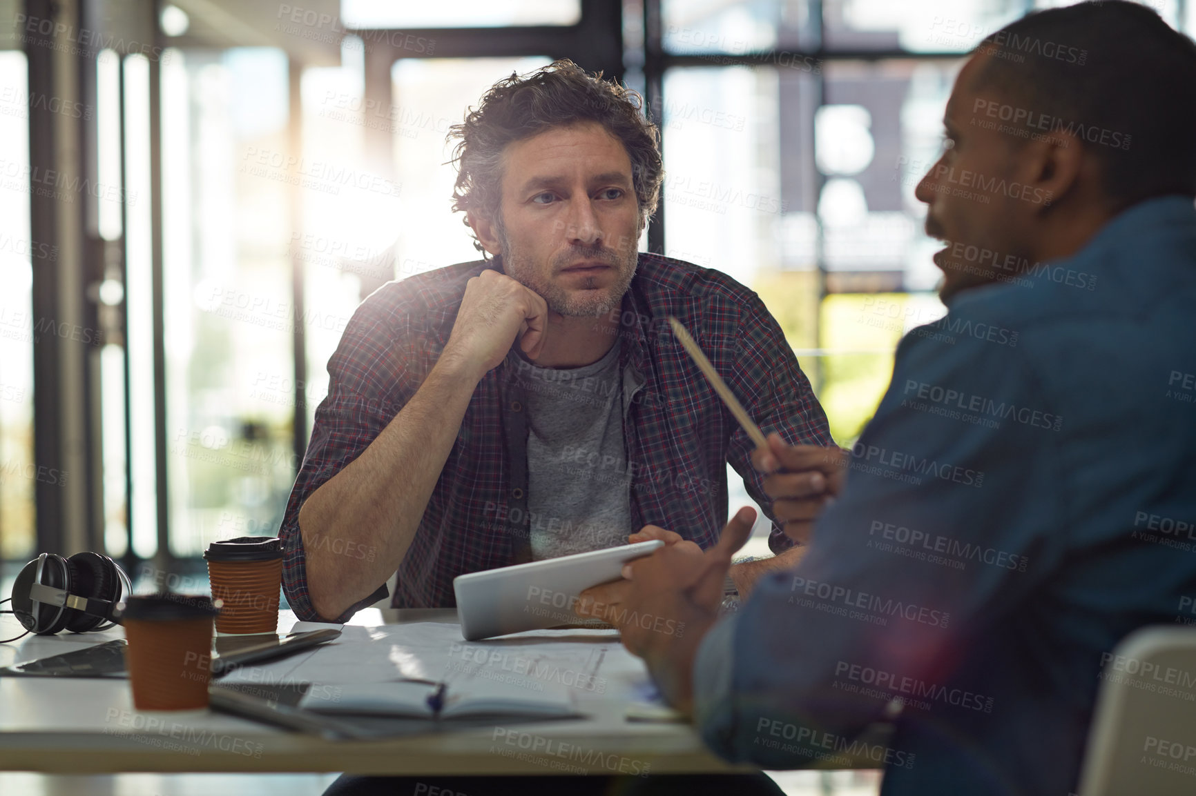 Buy stock photo Cropped shot of two businessmen talking in the office