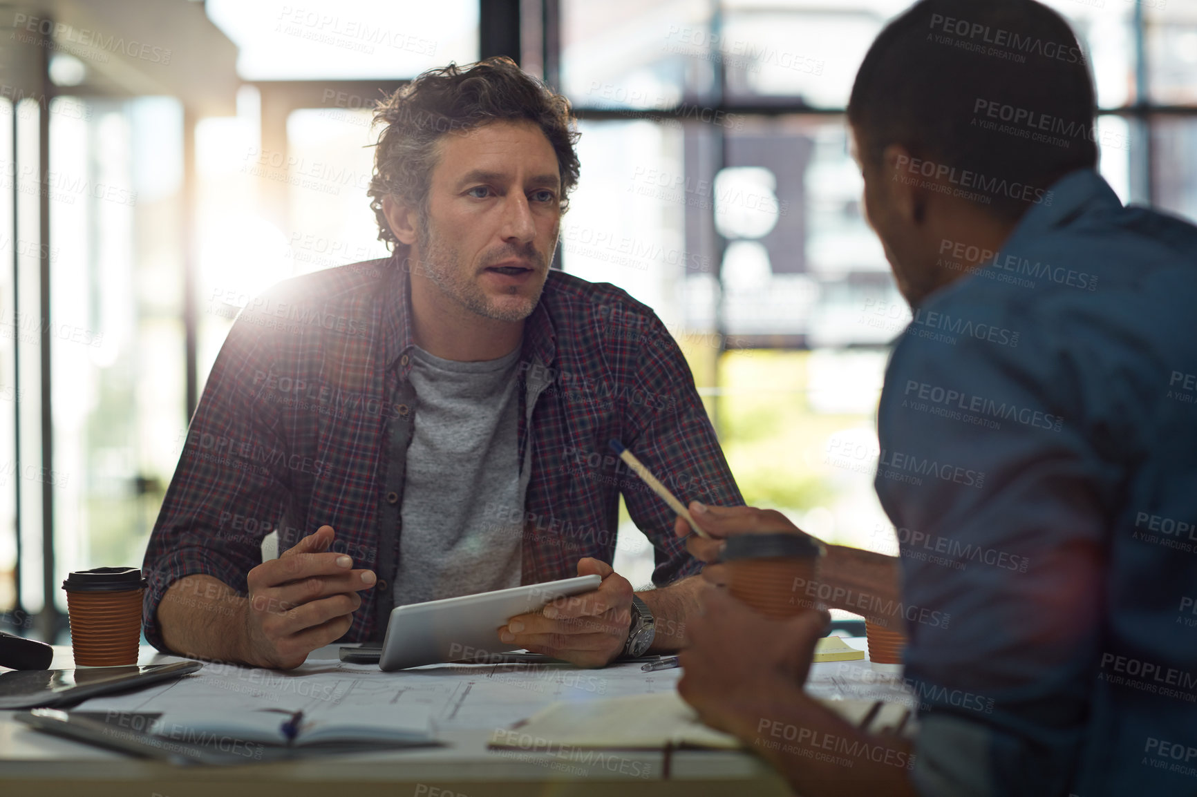 Buy stock photo Cropped shot of two businessmen talking in the office