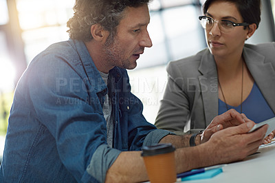 Buy stock photo Cropped shot of two business colleagues meeting in the office