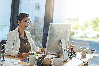 Buy stock photo Shot of a businesswoman working on a computer in an office