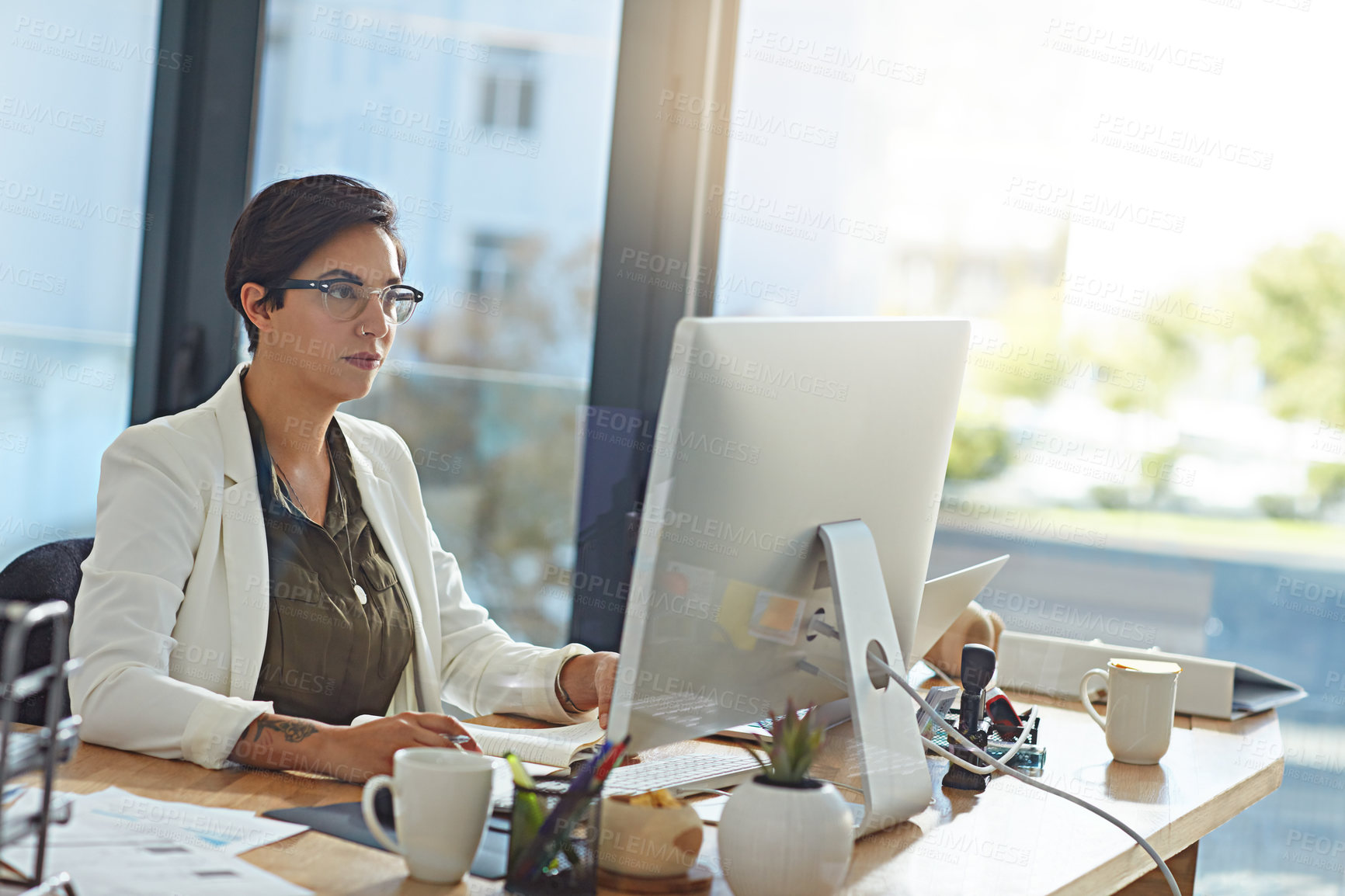 Buy stock photo Shot of a businesswoman working on a computer in an office