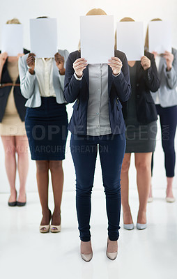 Buy stock photo Businesswoman, team and holding message on board in studio for anonymous recruitment of career. Professional, group and female people with blank paper hiding face for marketing as brand ambassador