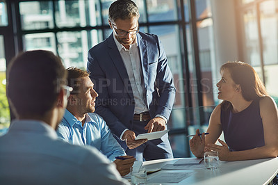 Buy stock photo Man, tablet and business people in meeting for planning, goals and mission at desk with diversity. Teamwork, mobile tech and leadership for vision, collaboration and innovation in financial company