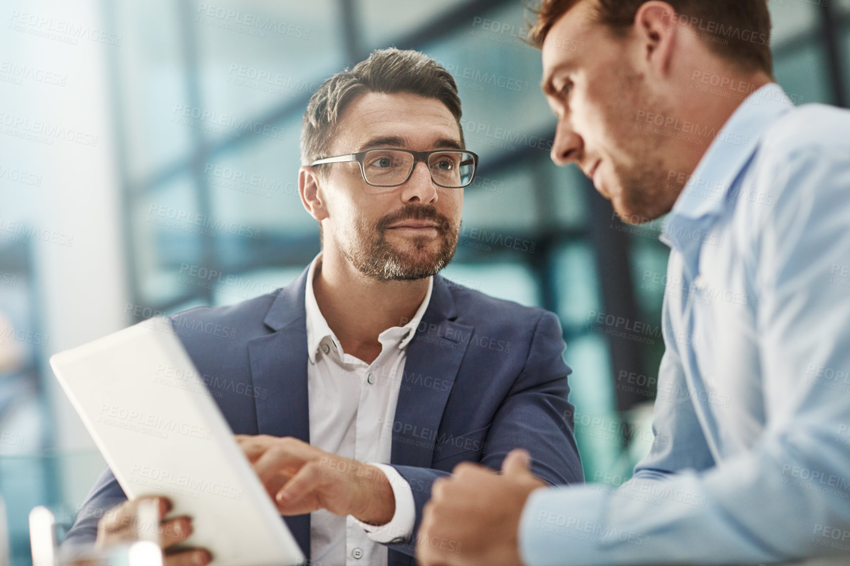 Buy stock photo Cropped shot of two businessmen meeting in the office