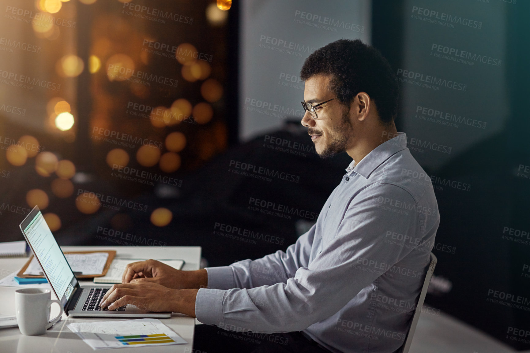 Buy stock photo Businessman, laptop and typing with smile for research, analysis or web design on desk at the office. Employee man sitting and working on computer late at night in dedication to meet project deadline