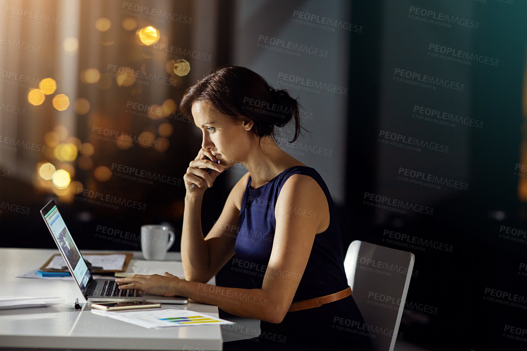 Buy stock photo Shot of a businesswoman using a laptop while woking late at the office