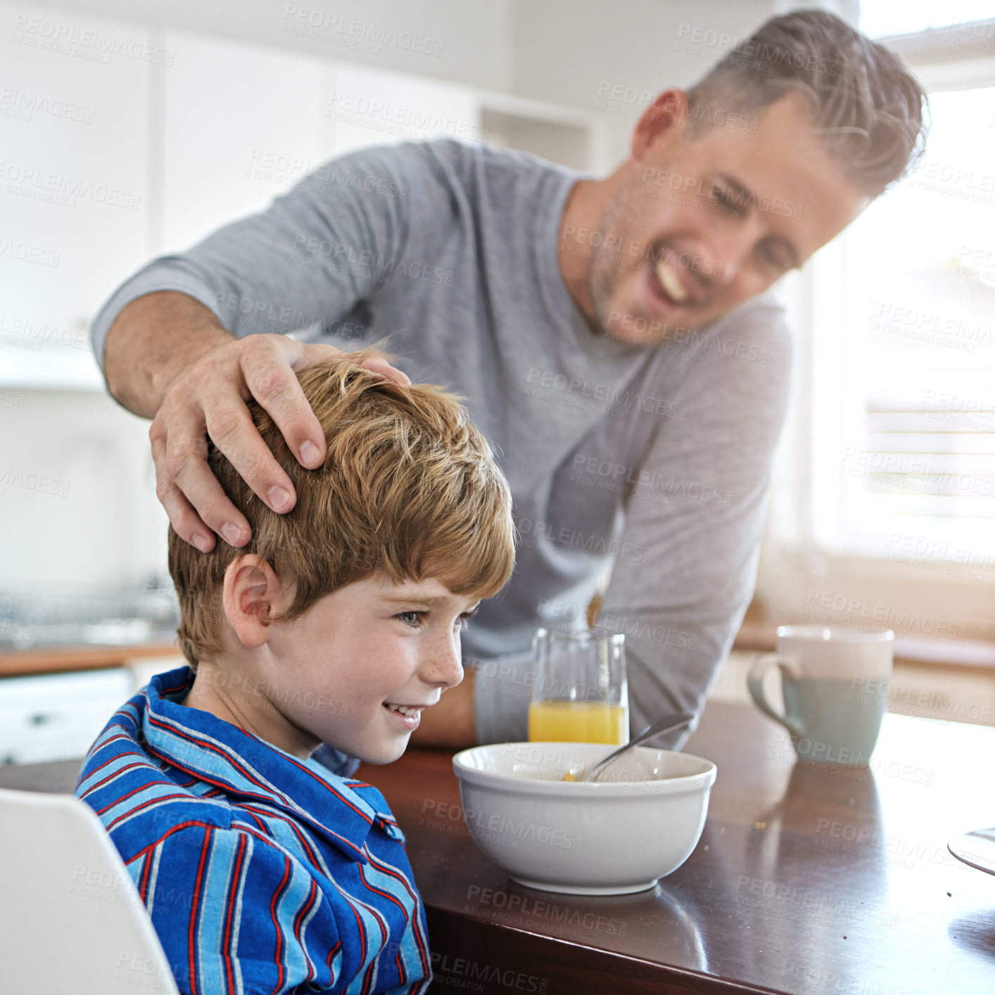 Buy stock photo Kitchen, eating and dad with child for breakfast together on weekend for nutrition at home. Happy, bonding and father enjoying morning food with boy kid for connection or family time in house.