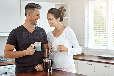 Buy stock photo Shot of a couple having their morning coffee