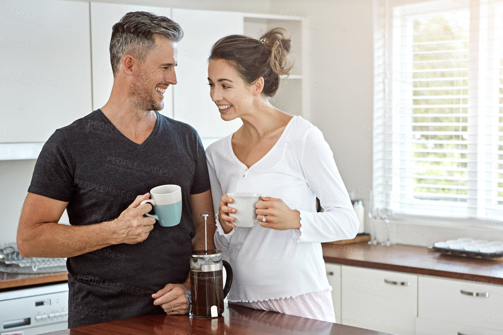 Buy stock photo Shot of a couple having their morning coffee