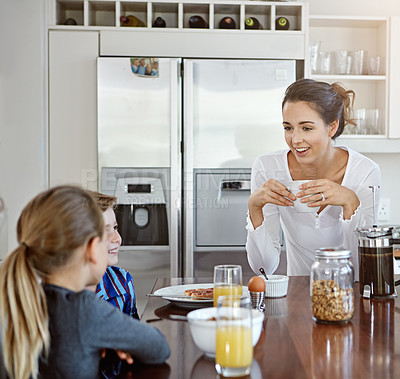 Buy stock photo Shot of two children having breakfast with their mother