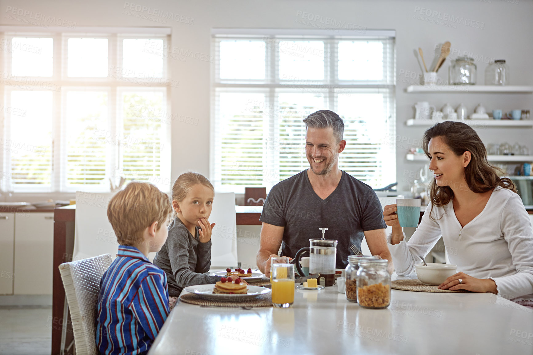 Buy stock photo Shot of a family having breakfast together