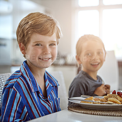 Buy stock photo Shot of a sister and brother having breakfast