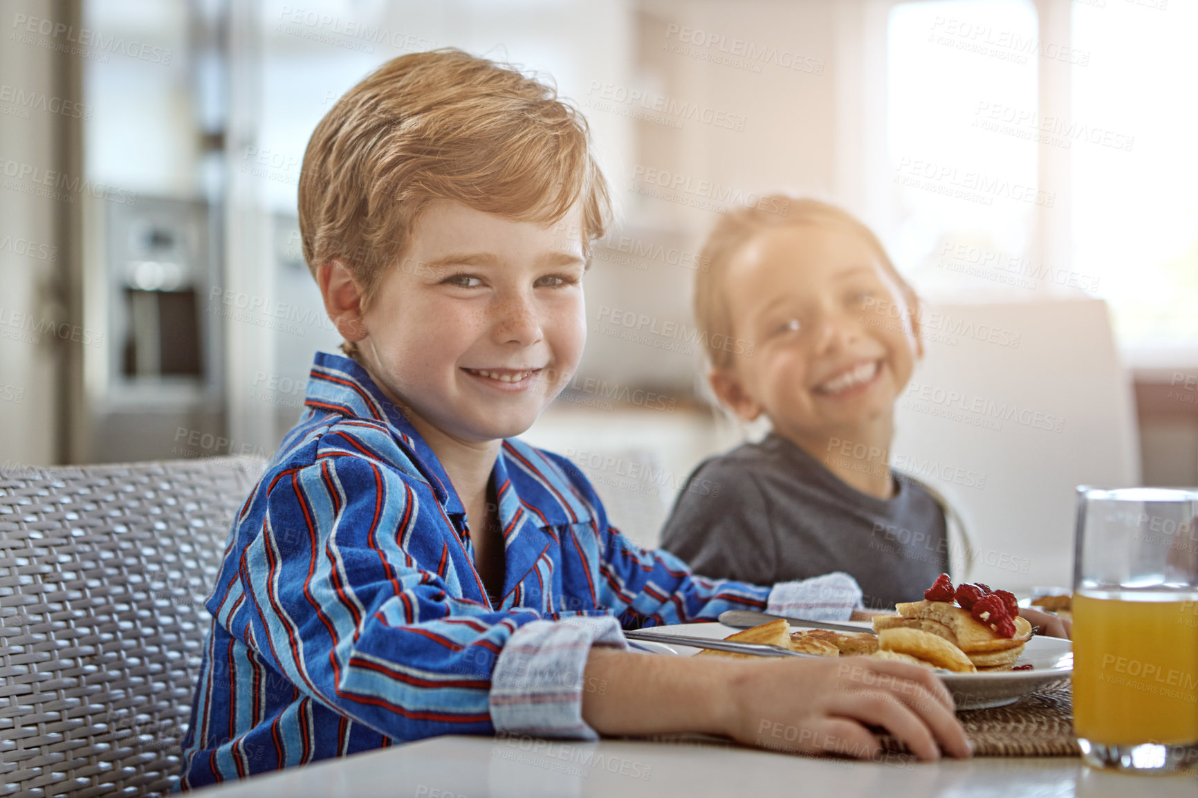 Buy stock photo Shot of a sister and brother having breakfast