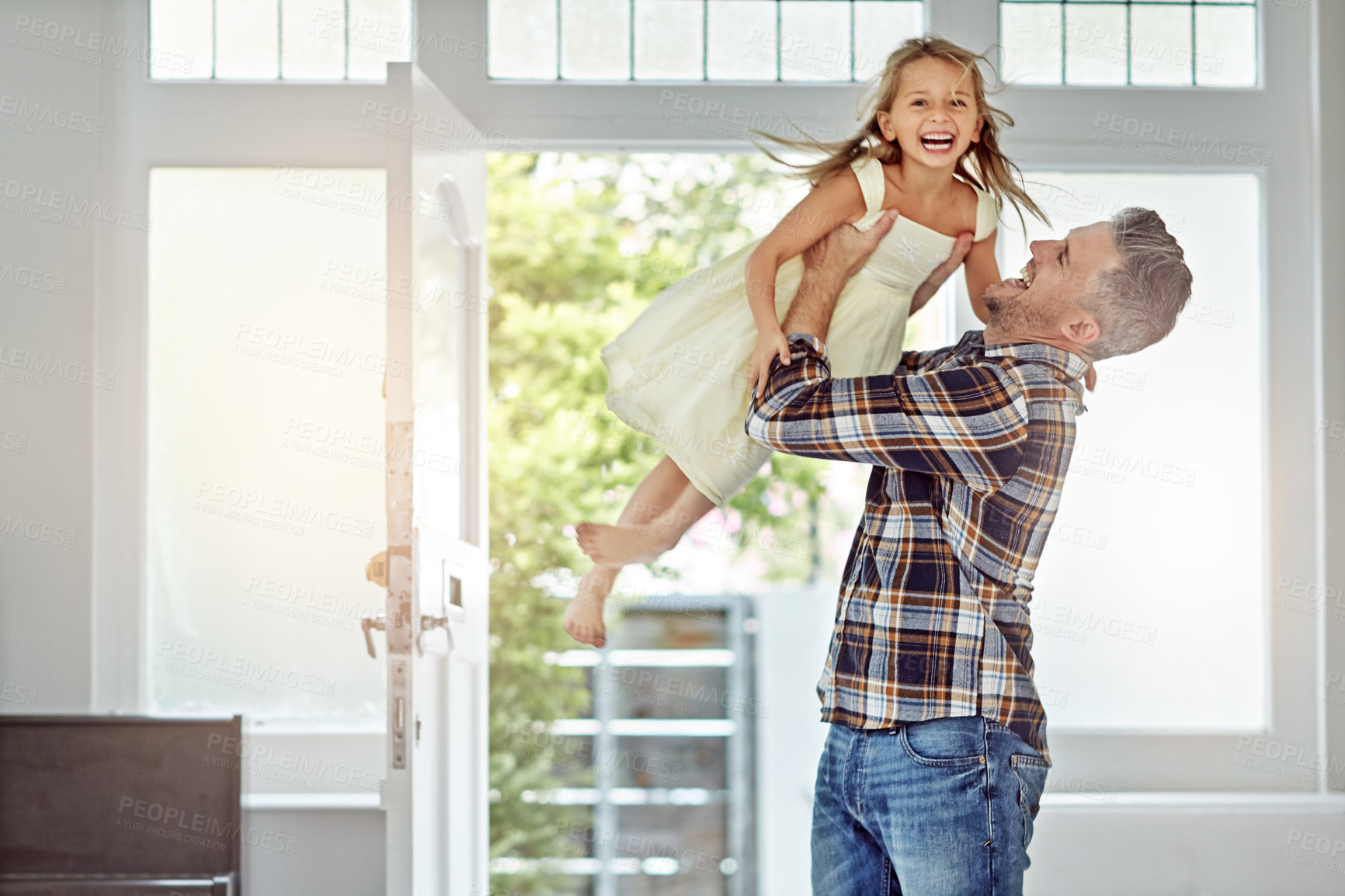 Buy stock photo Happy, love and father carrying a girl in their modern family home for fun, care and happiness. Smile, bonding and mature man playing with his excited child daughter in their house in Australia.