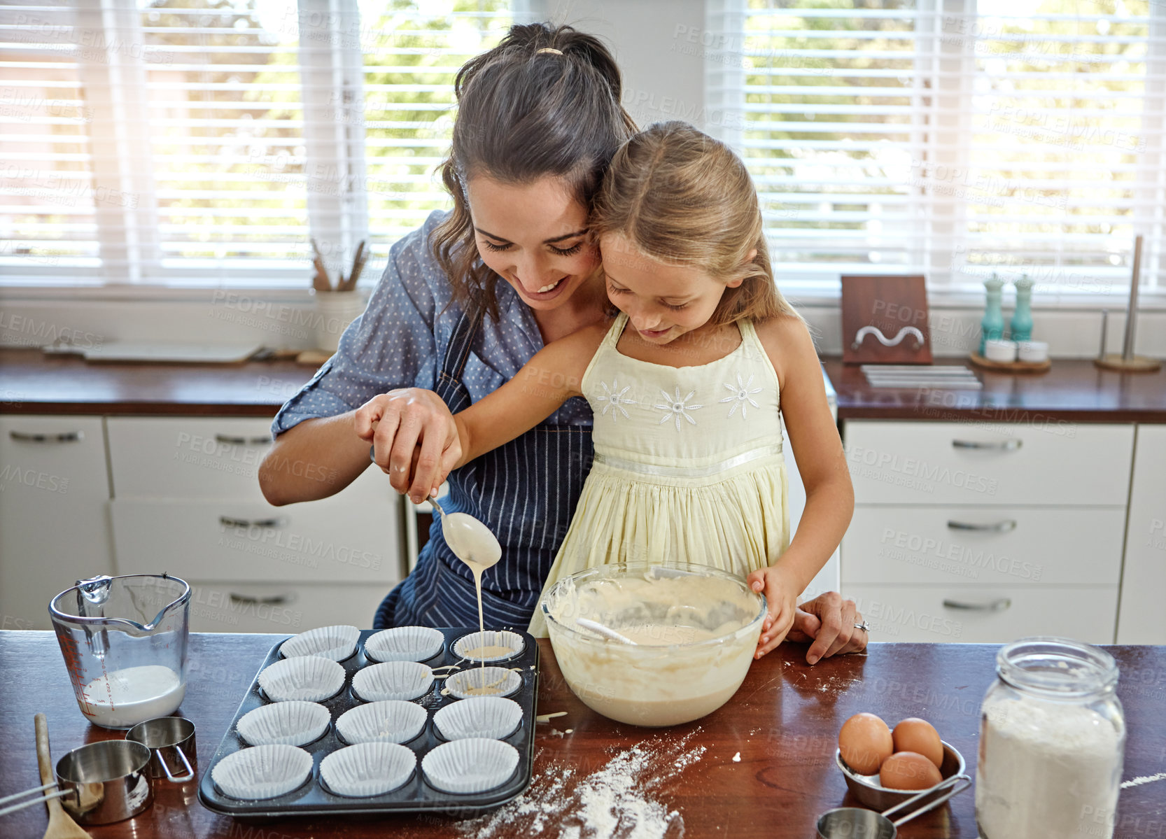 Buy stock photo Girl, teaching or baking with mom, cupcake and smile for bonding or learning to prepare dessert in home. Mixing, bowl or mother with child, kid or cooking skills for development, help or lunch recipe