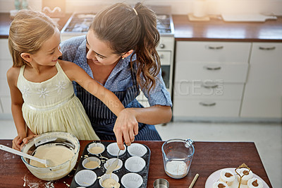 Buy stock photo Child, learning or baking with mom, cupcake and smile for bonding or teaching to prepare dessert in home. Above, bowl or mother with girl, kid or cooking skills for development, help or lunch recipe