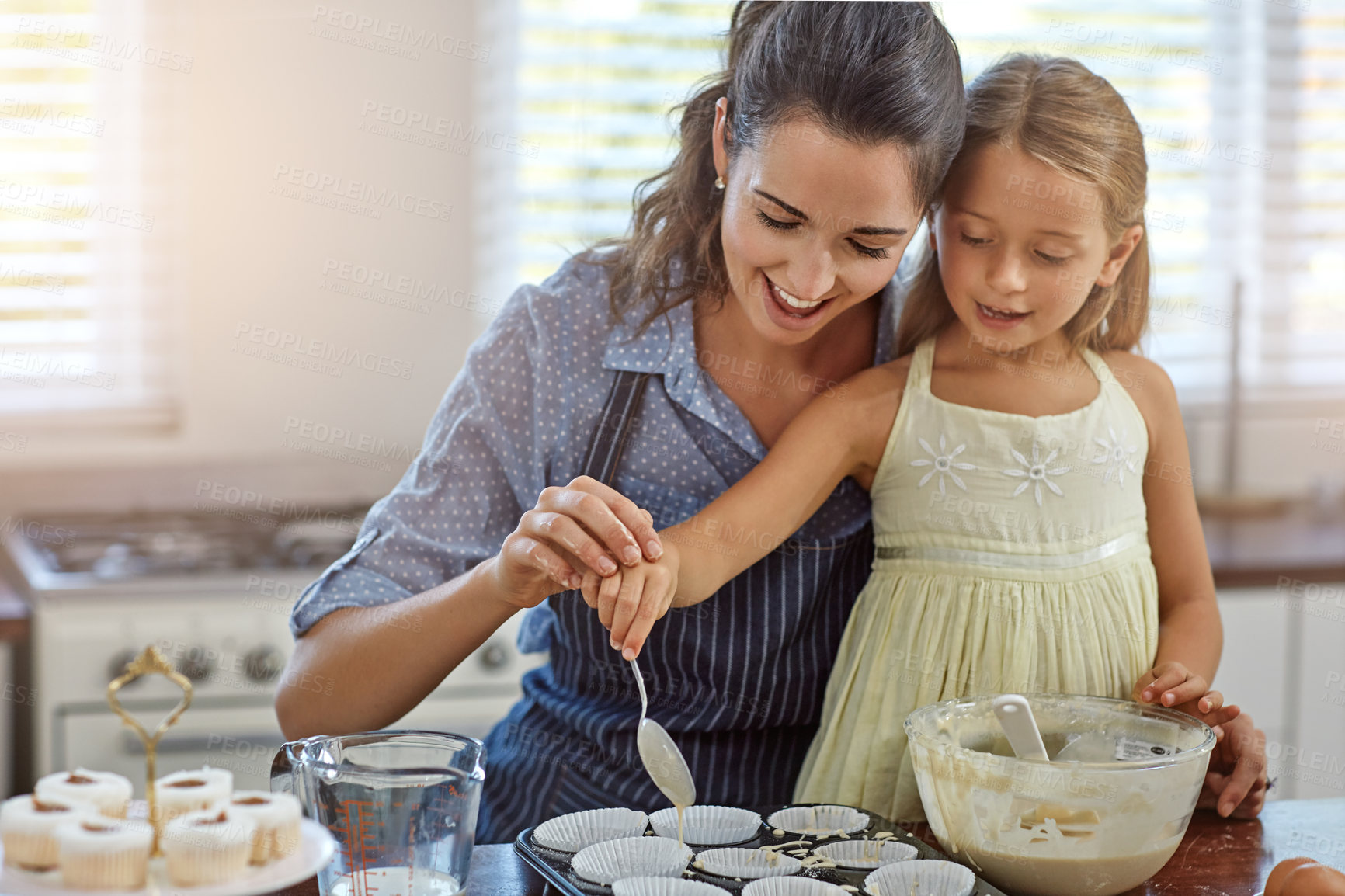 Buy stock photo Kid, bake or learning with mom, love or support for bonding, care or teaching dessert recipe. Food, family or happy mother with child, girl or cooking skills for development, help or cupcakes in home