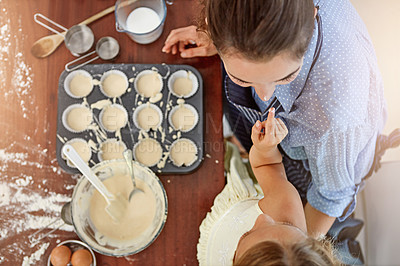 Buy stock photo Cropped shot of a mother and her daughter baking in the kitchen