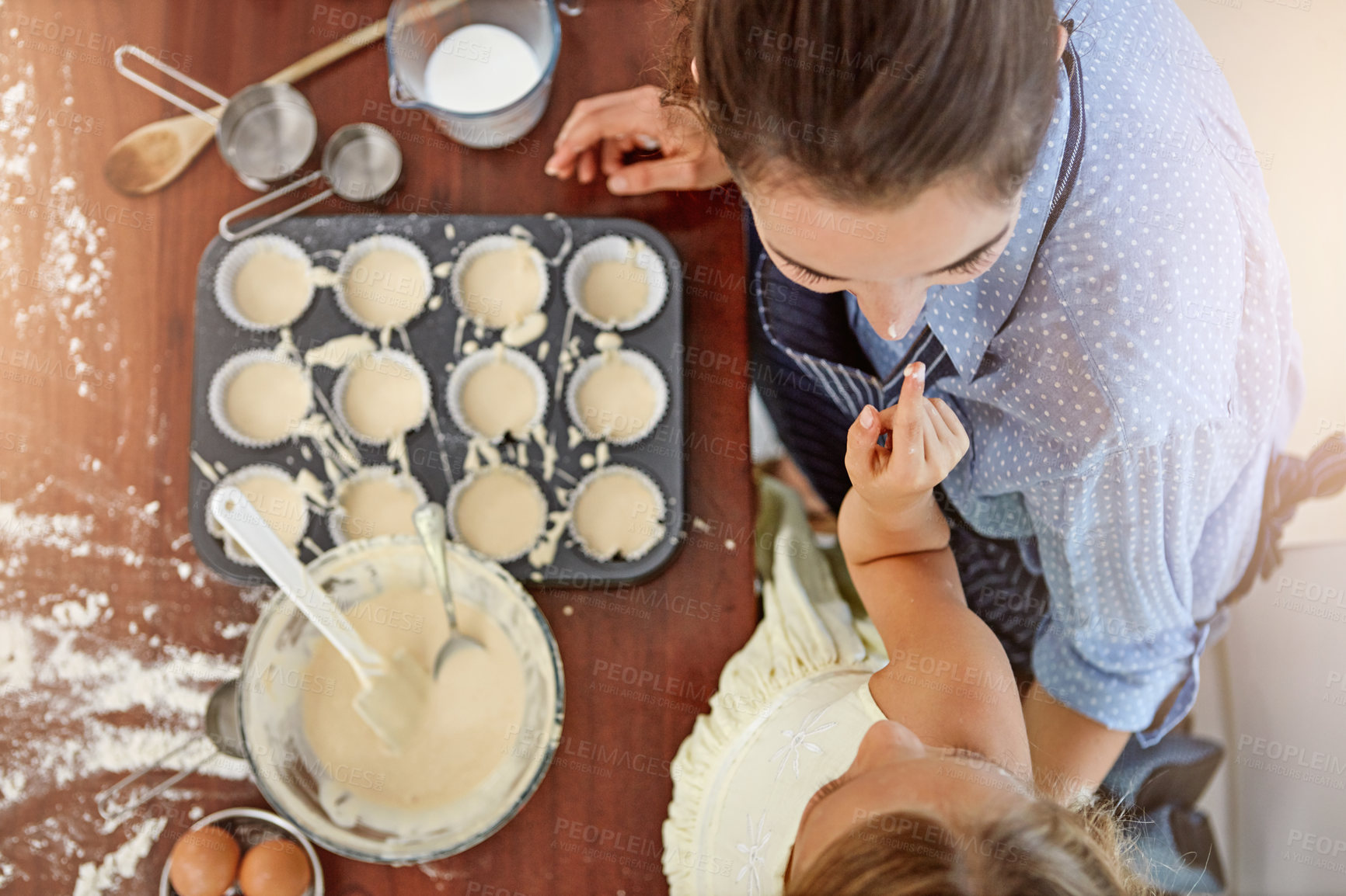 Buy stock photo Child, playing or baking with mom, top view and flour for bonding or learning dessert recipe. Parent, nose or mother teaching girl kid cooking skills for development, cupcakes or funny joke in home