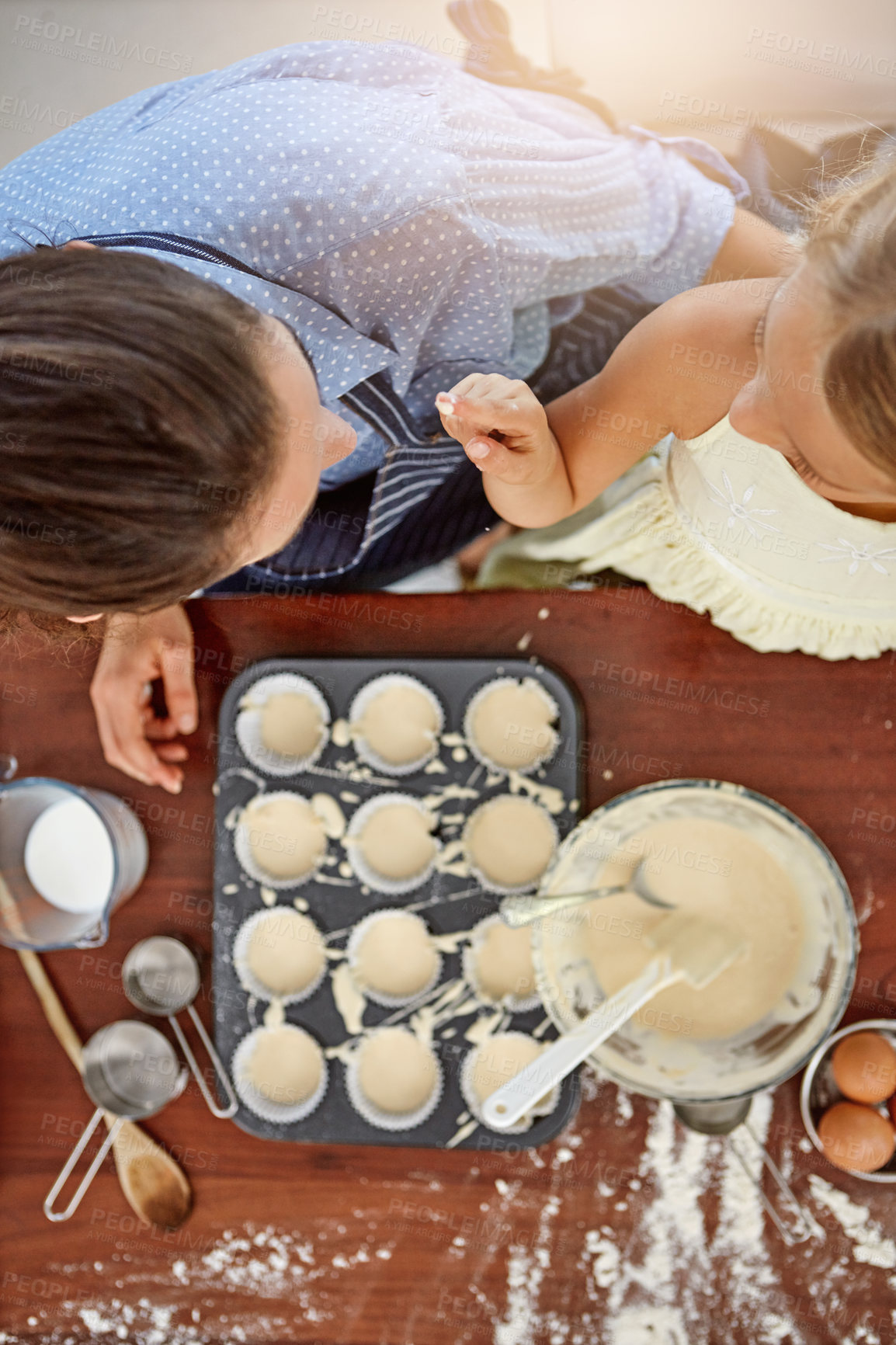 Buy stock photo Kid, playing or baking with mom, top view and flour for bonding or learning dessert recipe. Parent, nose or mother teaching girl child cooking skills for development, cupcakes or funny joke in home