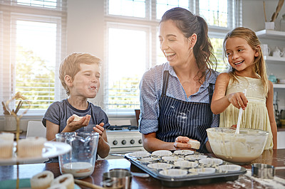 Buy stock photo Shot of a mother baking in the kitchen with her daughter and son