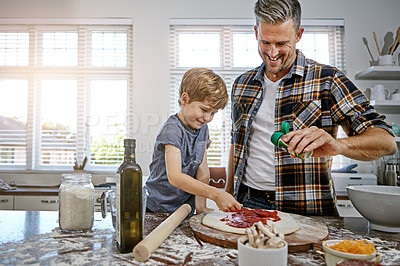Buy stock photo Shot of a father and his son making pizza at home