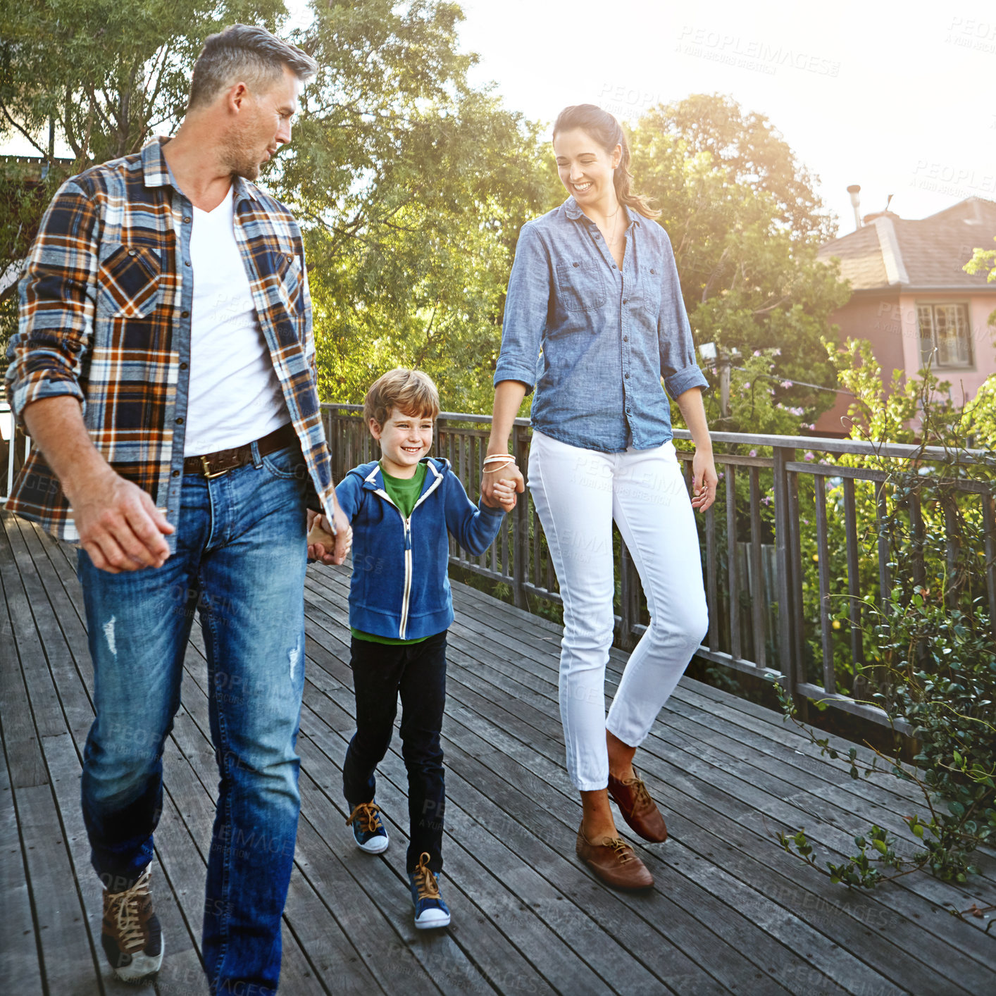 Buy stock photo Shot of a happy family of three spending time together outdoors