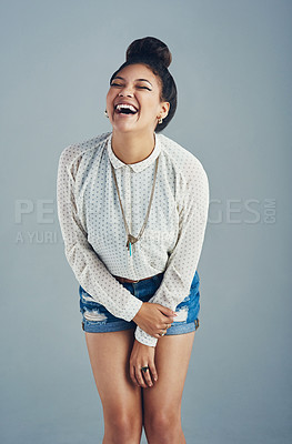 Buy stock photo Studio shot of an attractive young woman laughing against a gray background