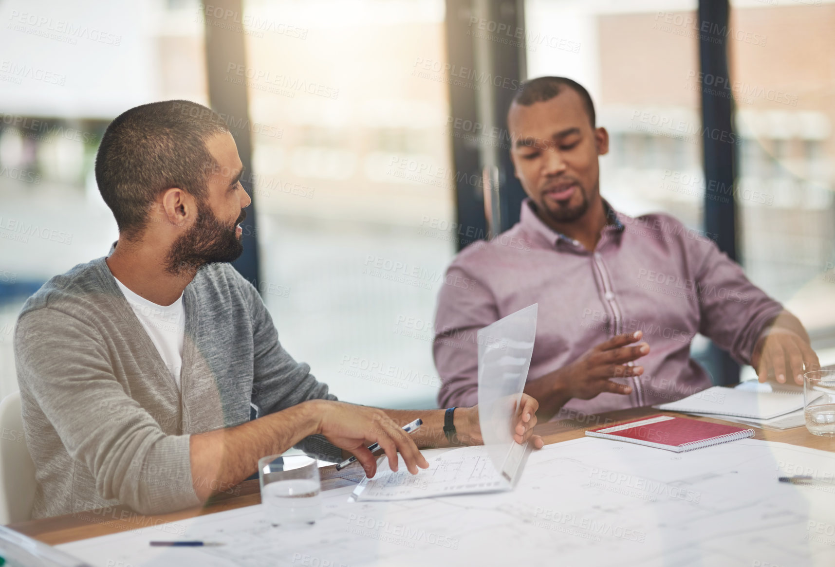 Buy stock photo Cropped shot of two young businessmen in a meeting