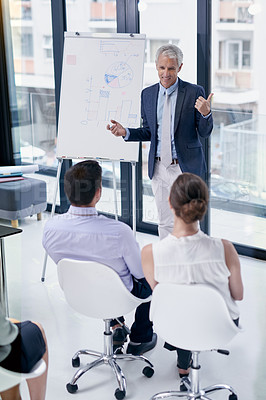 Buy stock photo Shot of a businessman giving a presentation to colleagues in an office