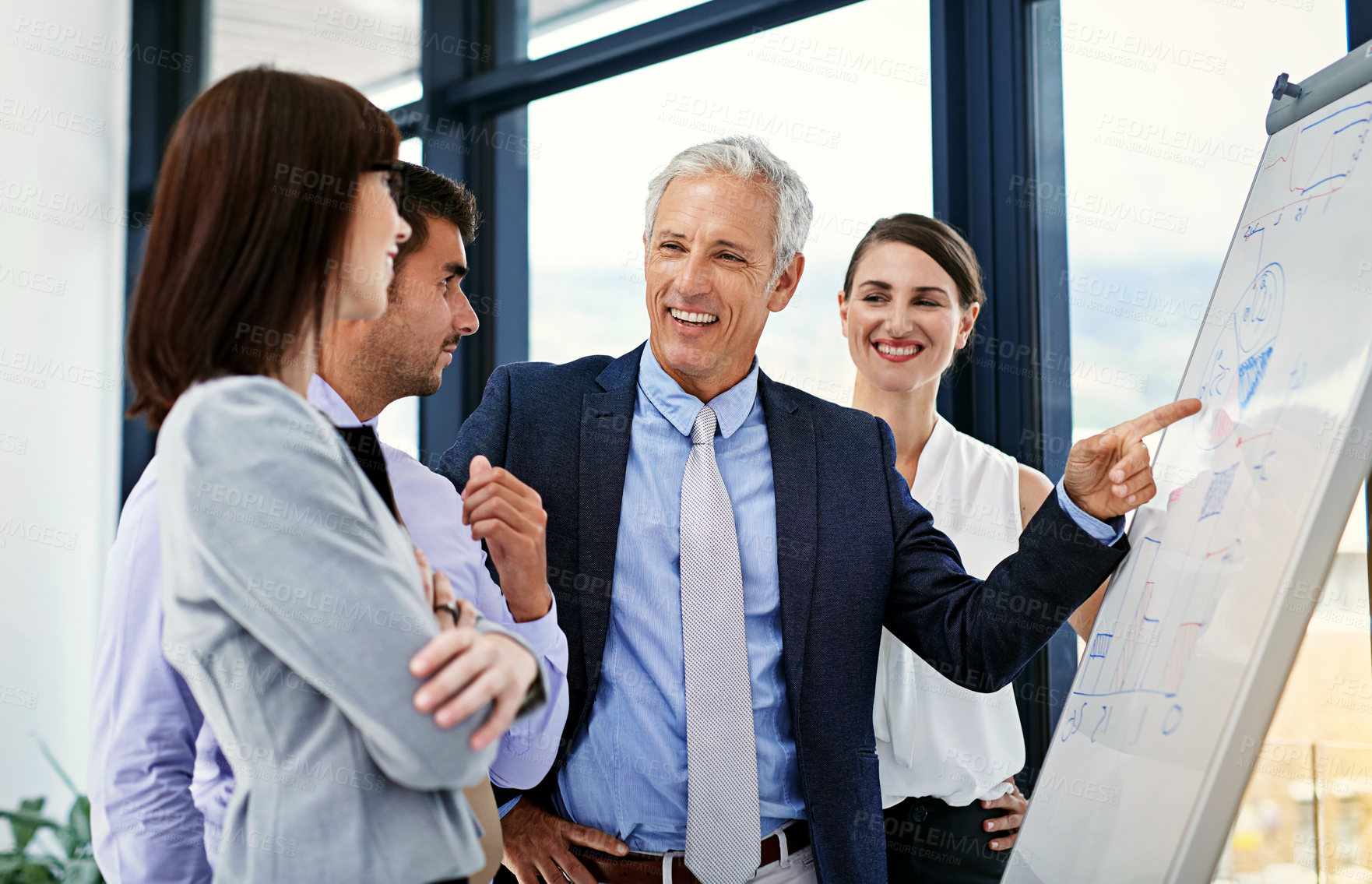 Buy stock photo Shot of a businessman giving a presentation to colleagues in an office