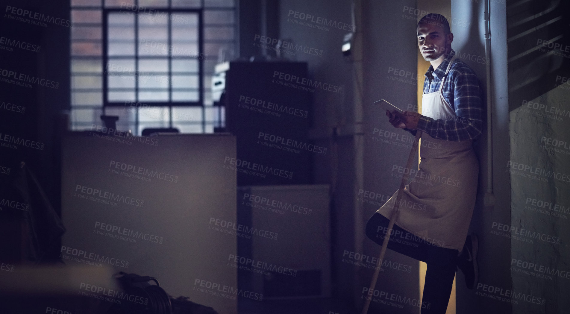 Buy stock photo Portrait of a young man working late on a digital tablet in his coffee shop