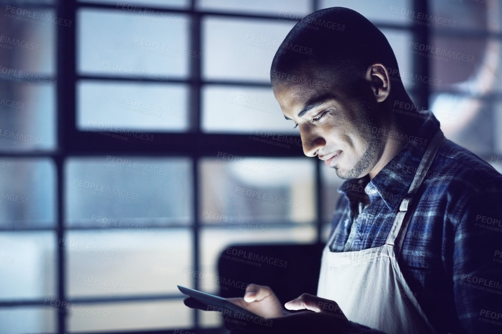 Buy stock photo Small business, night or man in coffee shop, tablet or startup with typing, connection or service. Person, entrepreneur or barista with tech, evening or communication with website info or digital app