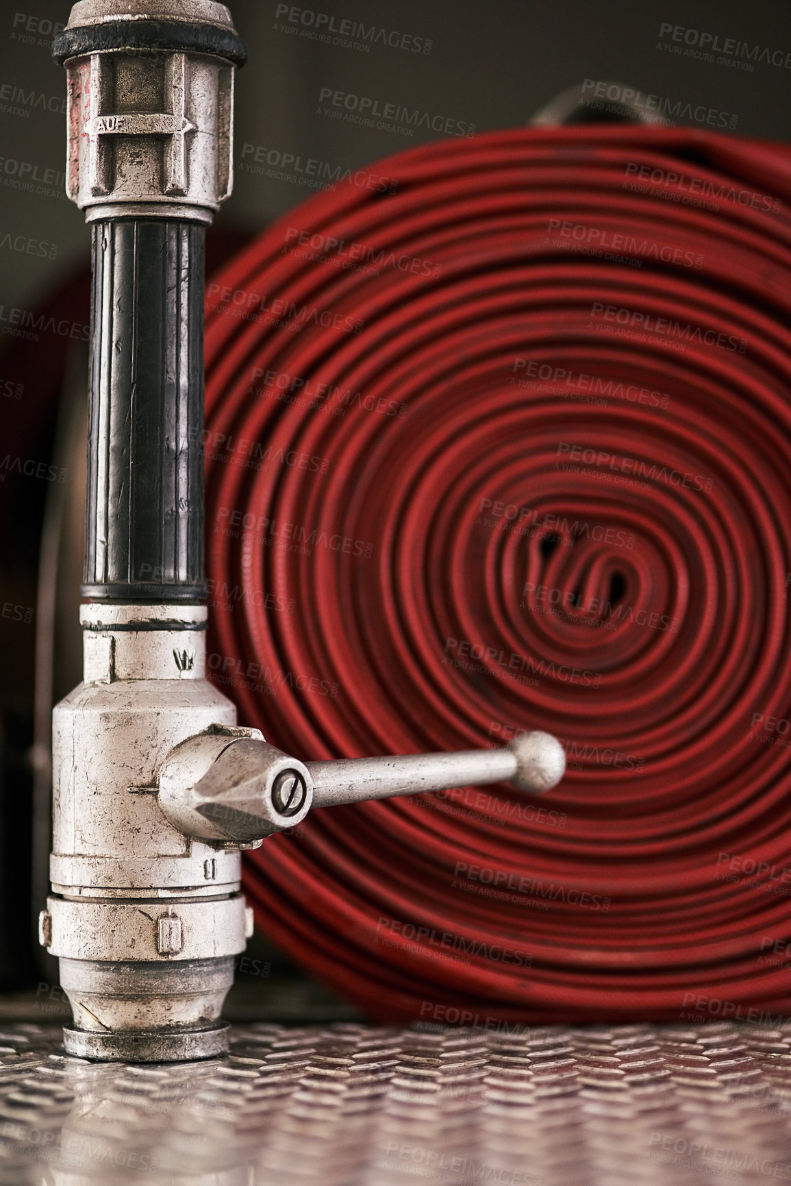 Buy stock photo Emergency, equipment and pipe with red fire hose for security, danger or health and safety at station. Closeup of gear, tool or pressure extingusher ready in rescue, service or firefighting operation