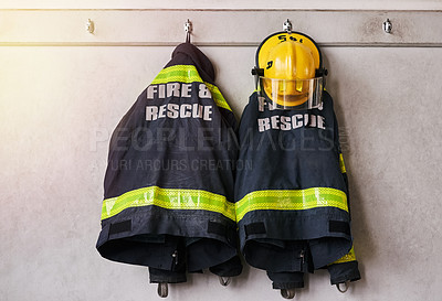 Buy stock photo Cropped shot of firemen's clothing hanging from a wall