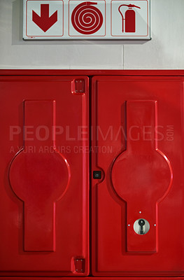 Buy stock photo Fire, sign and box with extinguisher for emergency, danger and rescue from flames or heat. Firefighting, hydrant and red locker with gear, equipment and water hose for health and safety at station