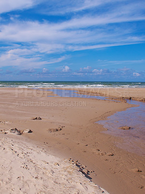 Buy stock photo Landscape and scenic view of a sandy beach, tidal ocean and a blue sky with copyspace in summer. Seascape of a remote and private beach.